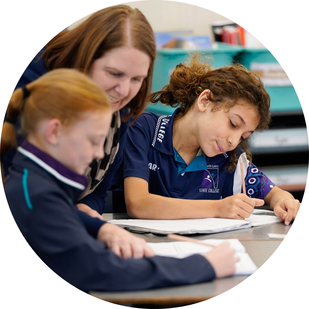 Teacher in classroom with two students