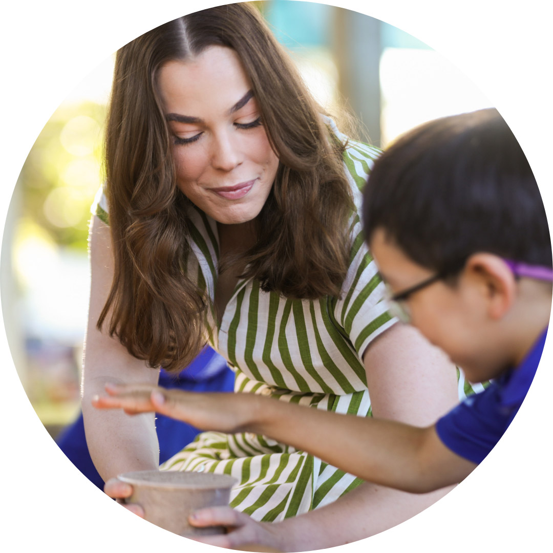 teacher with prep student playing outdoors